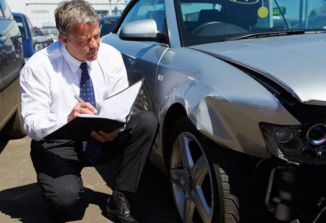 young woman filling out paperwork for auto insurance